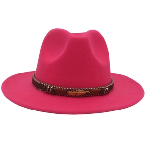 Detail of fuchsia wool fedora with brown beaded band and golden feather metal accent