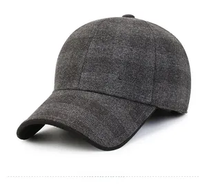 Detailed close-up of dark grey wool baseball cap with metallic logo and textured fabric
