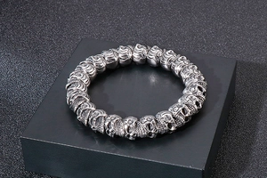 Detailed view of vintage punk style stainless steel skull bracelet with intricate carving