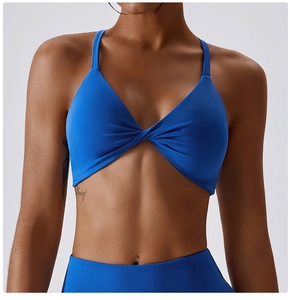 Macro detail of royal blue sports bra with elegant twist front knot and V-neckline