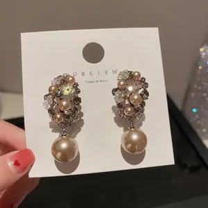 Elegant champagne pearl flower cluster drop earrings with crystals on white display card