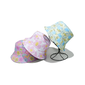 Detailed view of summer sun hats in various floral patterns like daisy and berry prints