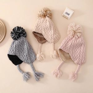 Winter knitted baby hat with earflaps and faux fur pom pom in grey, beige, and pink colors