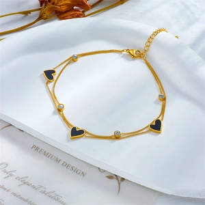 Golden double-layer chain anklet with black heart charm and sparkling zircon stones