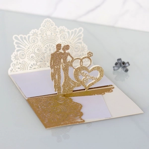 Detail of 3D pop-up wedding card with gold glitter Mr & Mrs silhouette and hollow design