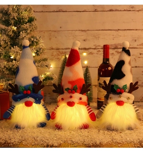 Cozy group of three glowing Christmas gnomes standing on snow with festive background