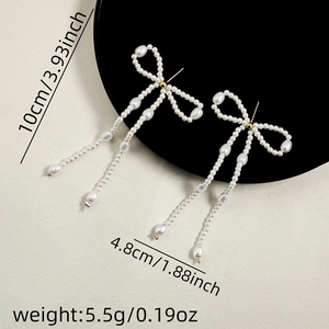 Detailed view showing product dimensions for pearl tassel bow earrings with silver needles