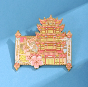 Detailed metal enamel pin featuring Wuhan Yellow Crane Tower with pink cherry blossoms