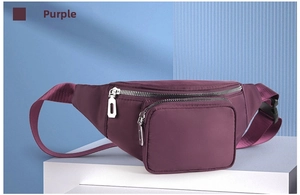Close-up of waterproof purple waist bag with silver zippers on geometric stands