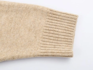 Close-up of the ribbed cuff and soft wool texture on the beige hooded cardigan