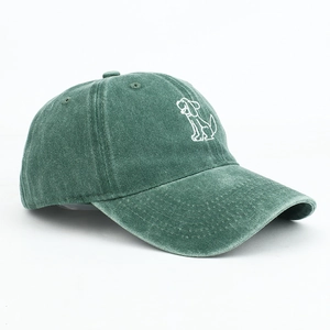 Detail showing embroidered cartoon dog on vintage dark green washed cotton baseball cap