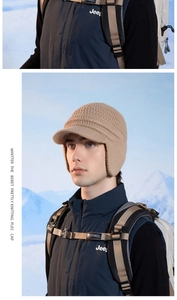Detailed knit texture and warm earflaps of a winter knit baseball cap with small brim