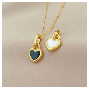 Vintage gold S925 silver necklace featuring double-sided black and white heart pendants