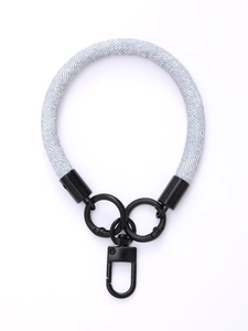 Close-up of light blue braided wrist strap with black metal rings and quick-release clip