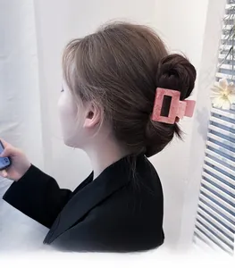 Pink marble texture square hair claw clip worn on hair with cutout rectangle design