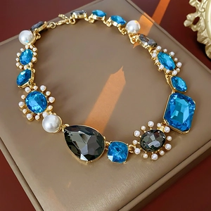 Detail of luxury vintage necklace with blue gemstones and pearls in a gift box