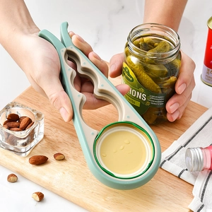 Manual 4-in-1 multi-functional jar opener tool shown opening a pickle glass jar