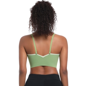 Close-up of light green sports bra with thin adjustable straps and V-shaped back design