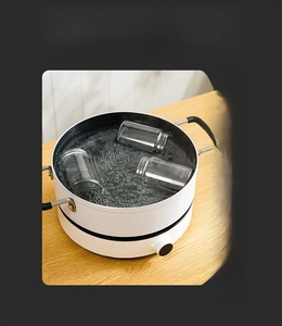 Detail of heat-resistant glass spice jars being sterilized in boiling water up to 250°C