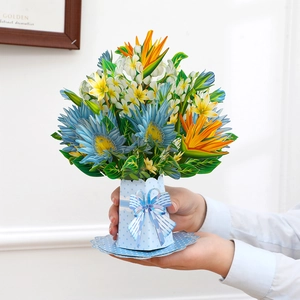 Close-up of 3D pop-up card featuring colorful flower bouquet with birds of paradise