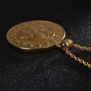 Detailed engraving on gold St. Benedict cross pendant with twisted rope chain necklace