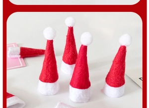 Close-up of mini red and white non-woven Christmas hats for lollipop decorations
