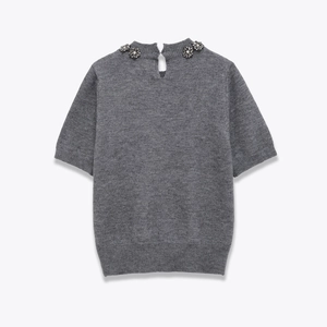 Detail of grey knit top with floral crystal embellishments and back teardrop cutout