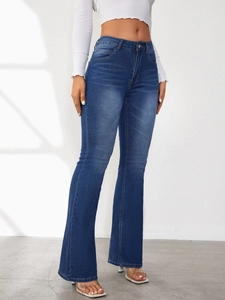 Detail view of high-waisted dark blue flare jeans with washed texture and slim fit design