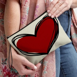 Cream canvas makeup bag with bold red heart print and black wristlet strap