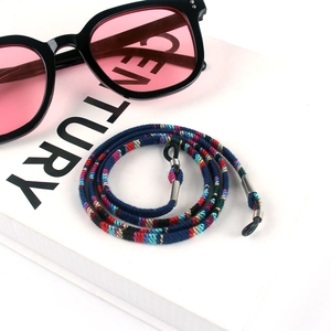 Detail of ethnic bohemian woven eyewear strap in navy blue with adjustable silicone loops