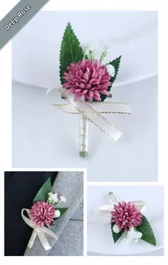 Detail of dusty rose wedding boutonniere with baby's breath and satin ribbon on suit