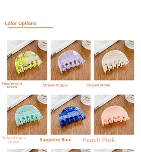 Detail view of medium acetate claw clips in various marbled patterns and vibrant colors