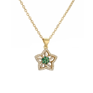 Detail of gold-plated star pendant with green gems and zircons on an O-chain necklace