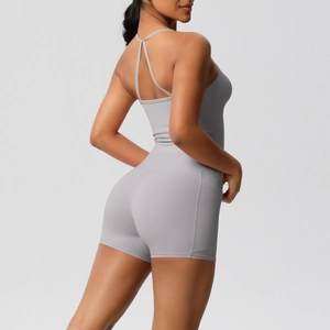 Detail of light grey yoga set featuring cross-back straps and functional side pockets