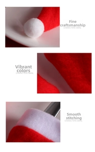 Detail of red plush Christmas hat fabric with white pompom and fine stitching craftsmanship