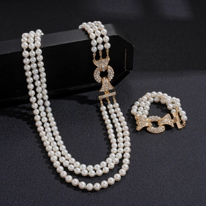 Three-layer faux pearl necklace and bracelet set with vintage rhinestone buckles