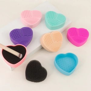 Detailed view of heart-shaped silicone makeup brush cleaner with multi-textured surface