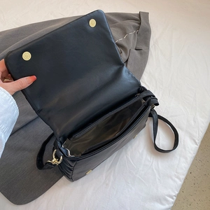 Quilted cotton texture crossbody bag in black with gold hardware and interior zip pocket