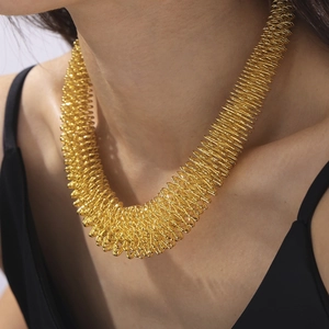 Golden chunky spring-shaped spiral necklace in a minimalist industrial hip-hop style