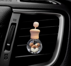 Detail of Mickey mouse donut cartoon car air freshener bottle on vent outlet