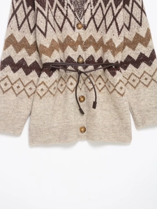Detail of knit cardigan with geometric jacquard pattern and leather-style waist belt