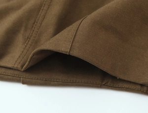 Detail of brown twill cotton fabric with reinforced double stitching for workwear skirt