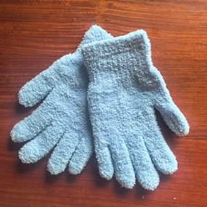 Close-up of light blue chenille gloves with soft plush texture and ribbed cuffs