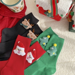 Cute Christmas socks with 3D plush Santa and Reindeer designs on white fuzzy background