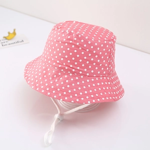 Pink cotton baby sun hat with white polka dots and adjustable drawstring chin strap