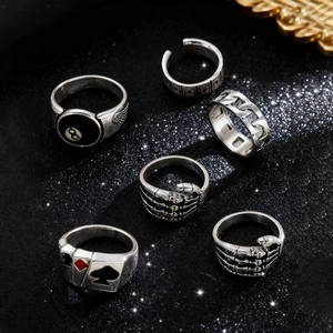 Macro view of vintage punk ring set with skull and billiard ball designs in silver finish