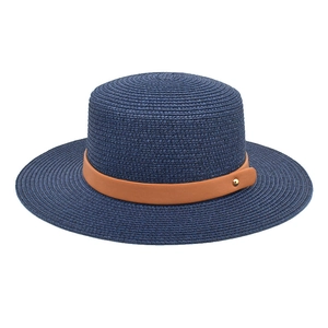 Detailed macro view of navy straw hat texture with brown leather band and gold rivet