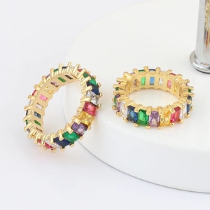 Detail view of colorful rectangle-cut zircon stones set in a gold-plated open band ring