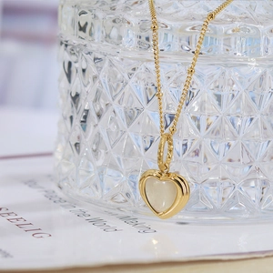 Elegant gold heart pendant necklace with shimmering mother of pearl on a fine chain