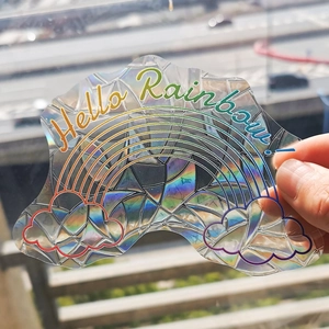 Detailed holographic suncatcher sticker featuring clouds and Hello Rainbow design